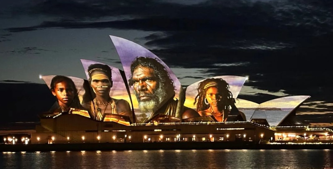 Sydney Opera House illuminated with portraits of trailblazers